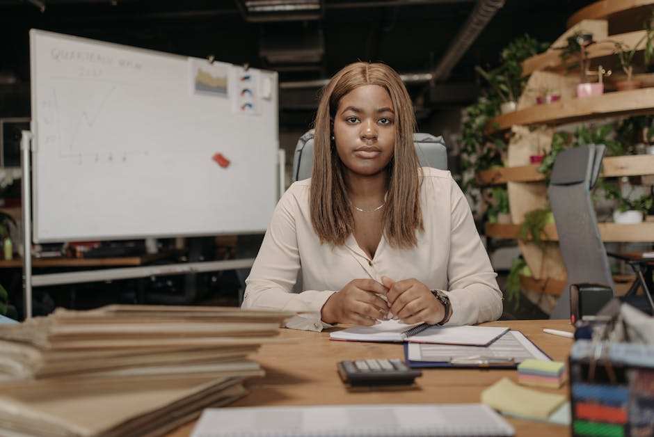 African American woman working diligently at a desk in a stylish office environment.